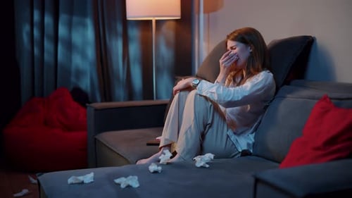 Sad Woman Crying on Couch at Night
