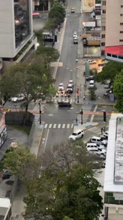 Aerial view of busy city intersection with traffic and pedestrians in Caracas