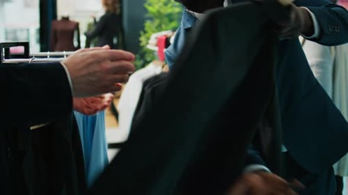 Store Employee Showing New Fashion Collection to Elderly Client