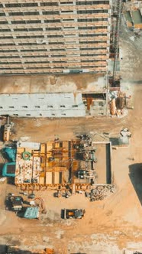 Aerial View of Construction Site and High-Rise Building
