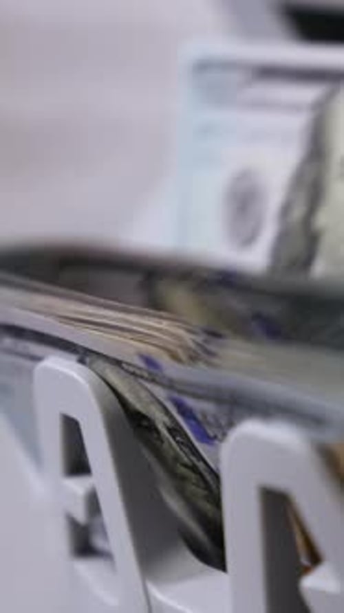 Money counting machine. Banknote counter are counting hundred dollar bills.