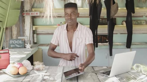 Man Using Tablet at Beachside Business