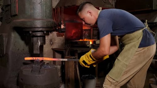 Blacksmith Forging Hot Metal Rod With Press