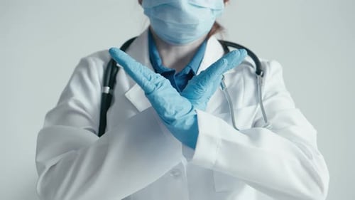 Doctor Crossing Arms in Protective Gear