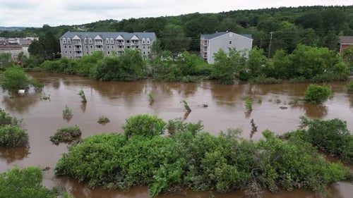 Flooded river overflowing into home backyards and residential property