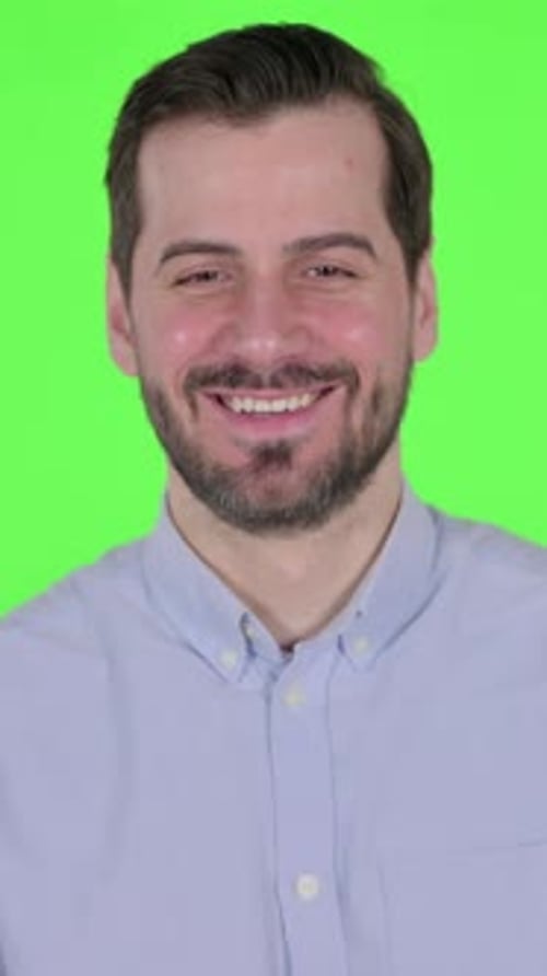 Portrait of Attractive Man Smiling at Camera, Green Screen, Vertical Video