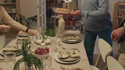People preparing a family meal at a table