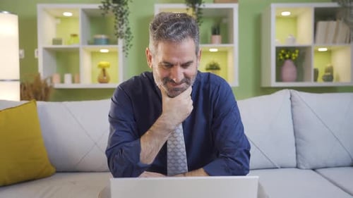Mature Man Working on Laptop at Home