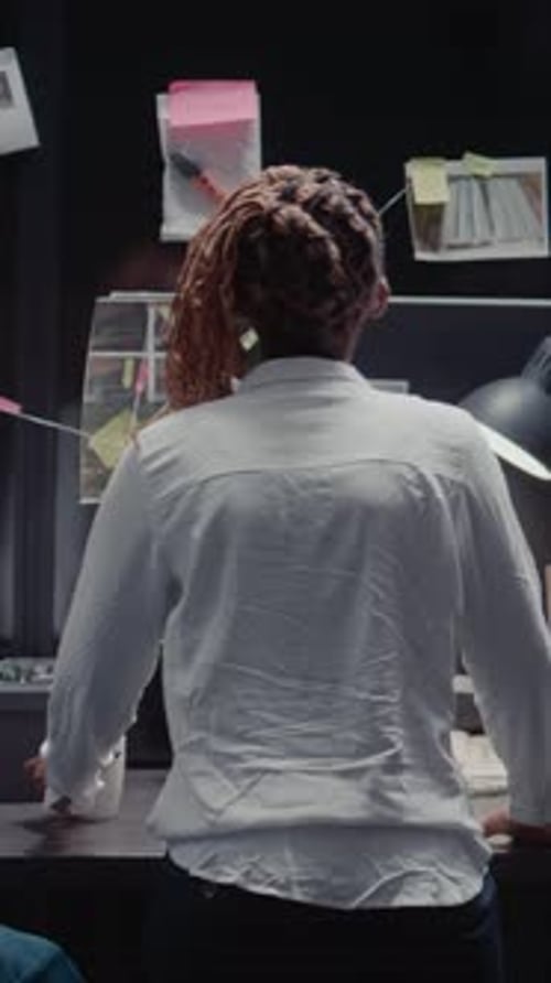 Vertical Video Law Agency Detective Reading Criminal Records in Archive