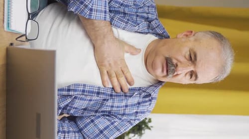 Vertical video of Old man with shortness of breath.