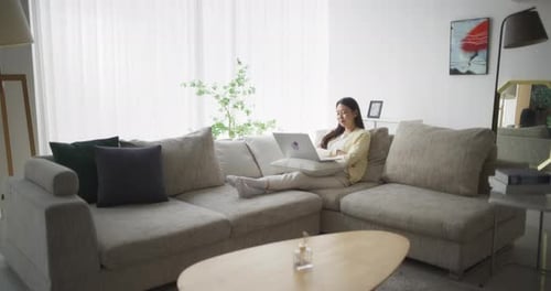 Woman Works on Laptop in Comfortable Home Interior