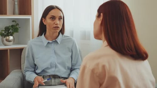 Woman Counseling Patient in Bright Office