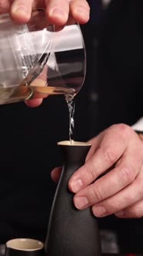 the bartender prepares a popular cocktail at the bar