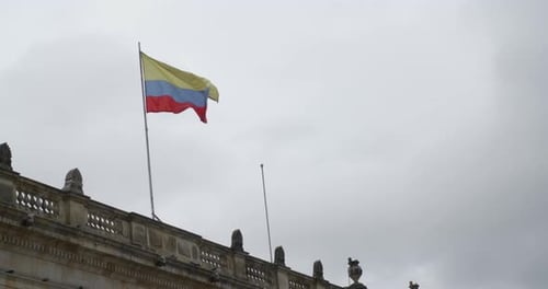 Flag Blowing on a Building on a Cloudy Day