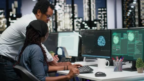 Team of Programmers in Office Working Together to Block Hacker Intrusion