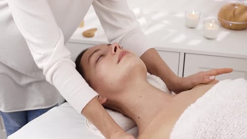 Woman Receiving Relaxing Face and Neck Massage
