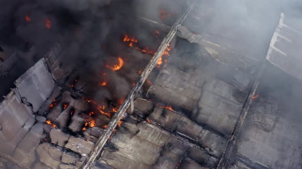 Large factory burned into ashes, aerial orbit flames and black smoke ...
