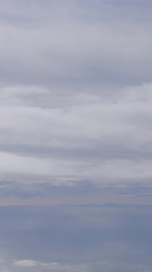 Serene Cloudy Sky Reflected on Calm Water Creating a Peaceful Atmosphere