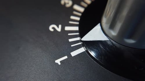 Detail shot. Rotating a variable resistor knob on old equipment, from scale 1 to scale 2.