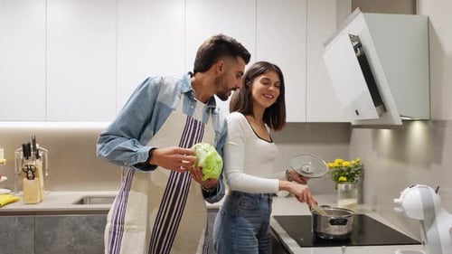 Couple Preparing Food Together in Modern Kitchen