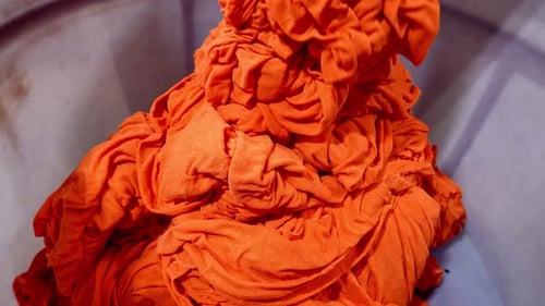Bright Orange Cloth Pile in Container