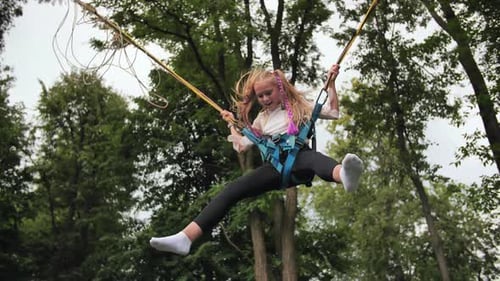 Teenage Girl Jumping on the Trampoline Bungee