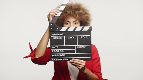 Woman Holding Clapperboard on White Background