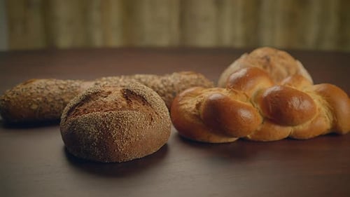 Variety of Breads on Wooden Table Close Up