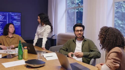 A Dynamic and Engaging Team Meeting is Taking Place in a Modern Office Environment