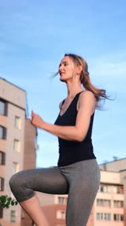 VERTICAL VIDEO POV Young Adult Blonde Woman Running in Place Outdoors in City Healthy Lifestyle