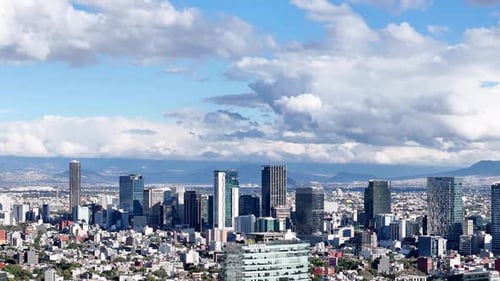 Modern City Skyscrapers Under a Dramatic Cloudy Blue Sky Horizon