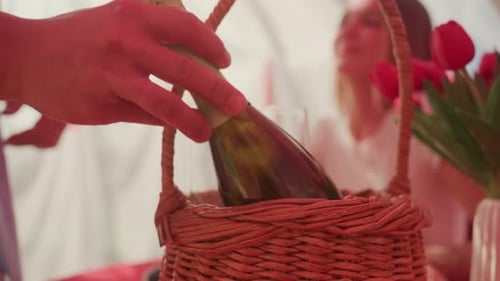 Man Takes Champagne From Picnic Basket