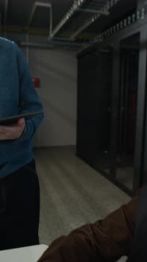 Two Network Engineers Discussing Work in Data Center