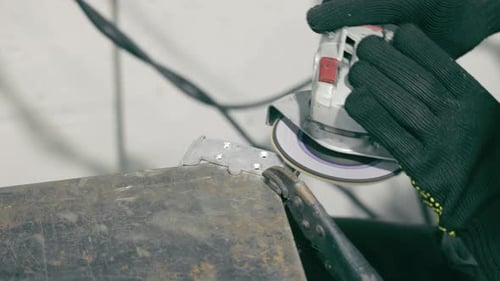 Grinding Metal Surface with Power Tool A Closeup Shot of a Worker Grinding a Metal Surface Using a