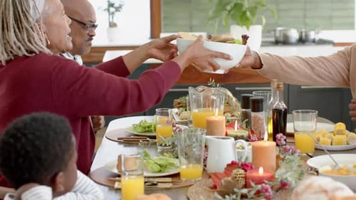 Family and Friends Sharing Meal Around Dining Table