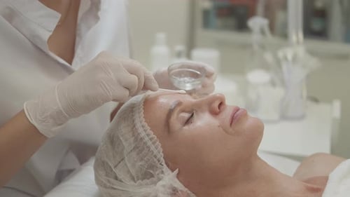 Woman Receiving Facial Treatment at a Clinic