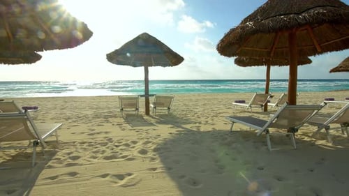 Beach chairs stand serenely on white sand beach of tropical island paradise