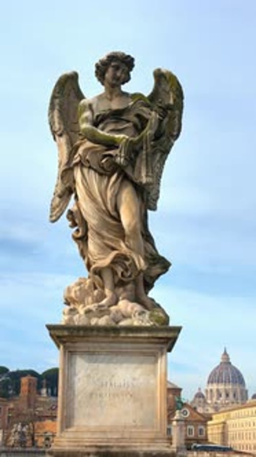 Marble statue of angel on Saint Angel Bridge in Rome, Italy. Vertical