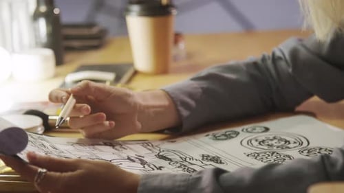 Designer Looking at Art Sketches Close Up