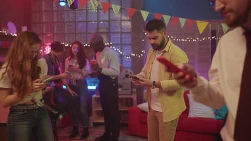 Friends at Party Focused on Phones
