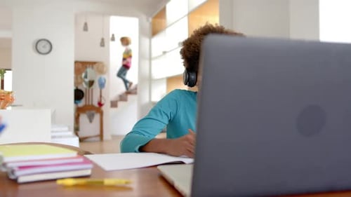 Child Studying Online at Desk with Laptop