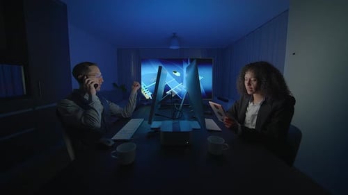 Business Professionals Are Engaging in Collaboration and Utilizing Technology at Night