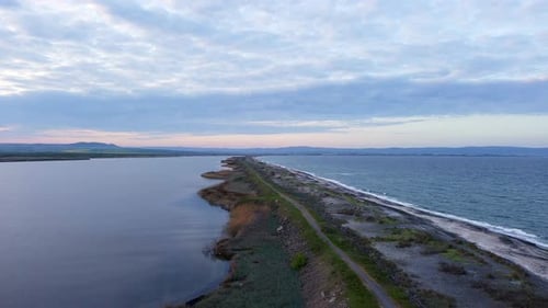 Bird's Eye View of Beach with Sand Grass and Stones Washed By Bay of Black Sea and Lake Under Sky in