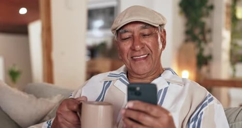 Senior Man Using Mobile Phone at Home