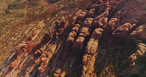Land of rocks with no greenery and rounded mountains. Aerial view of sunny desert in Utah, USA.