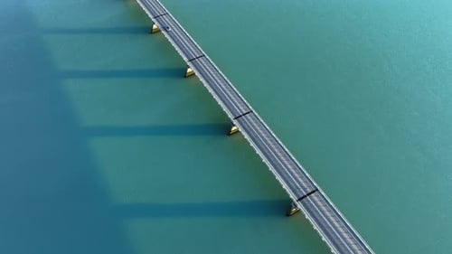 Aerial Drone View of Long Bridge Crossing Turquoise Fjord Waters