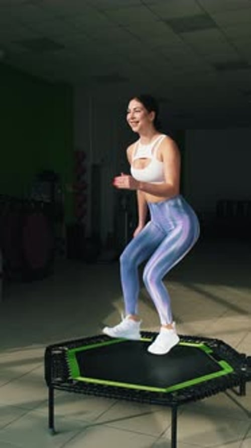 Woman Bouncing on Mini Trampoline for Fitness Exercise