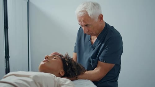 Woman Receiving Gentle Neck Massage from Therapist