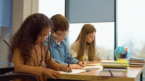 Children Studying and Writing in a Classroom