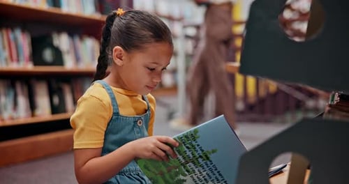 Reading book, child or girl in a library for a story in school campus for education on bookshelf